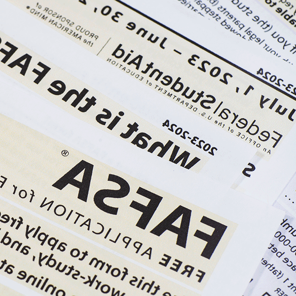 Closeup image of a FASFA form on a table with text reading “Federal Student Aid”